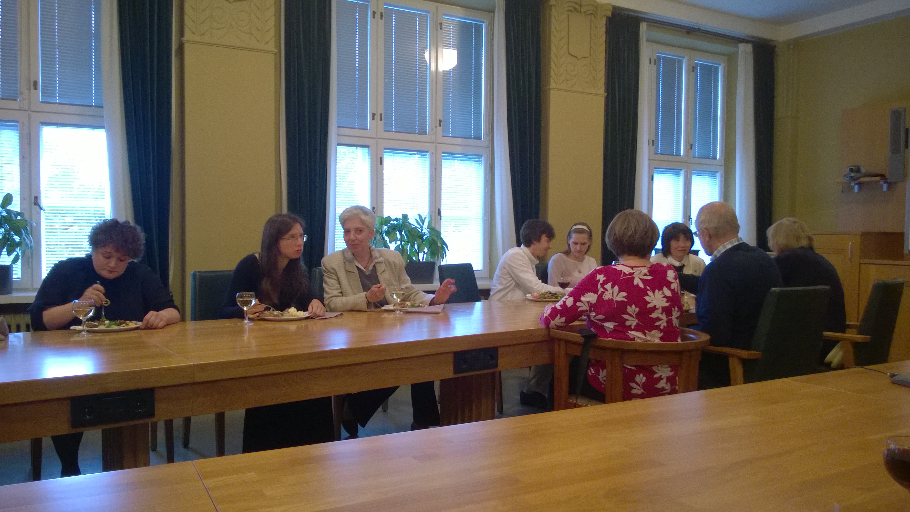 Eating dinner and conversing together at a reception hosted by the City of Joensuu.